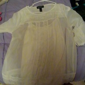 A shirt with white flowers and plants over it.